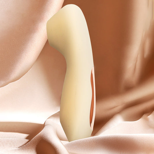 Sucksy air-pulse stimulator in Shifting Sand, a muted organic beige, showing the ergonomic stimulation nozzle and soft-touch silicone body.